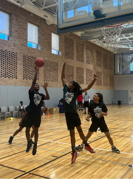 Basketball players jump for a rebound.